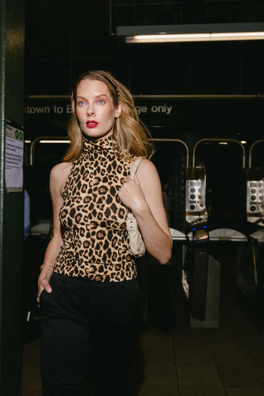 Model in an Anka Studios leopard turtleneck by the subway turnstiles, 33rd St Station